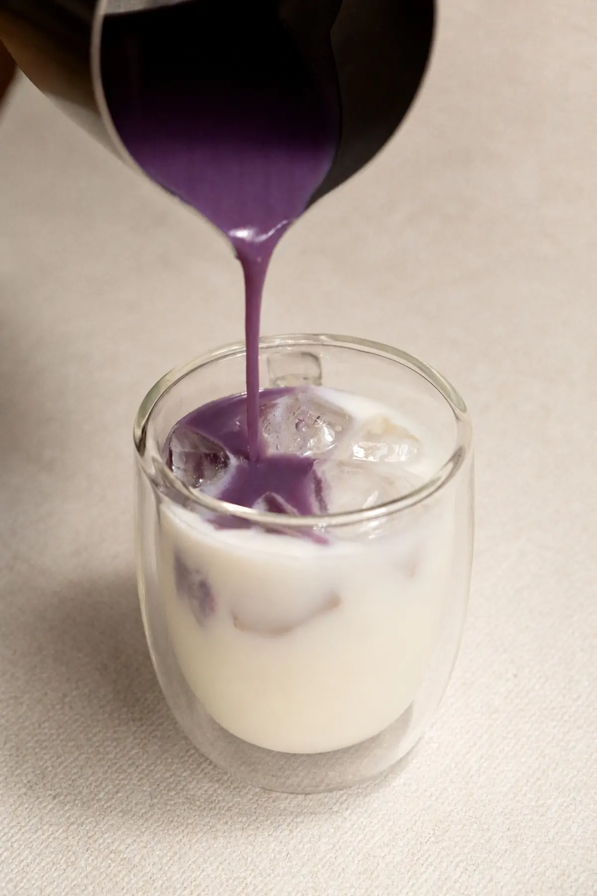 Real Philippine ube powder blended into milk and poured over ice for an ube latte